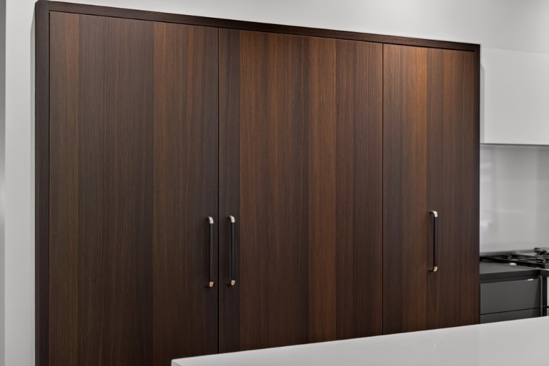 Fumed European White Oak refrigerator doors showing the random veneer layup, with long vertical pulls.